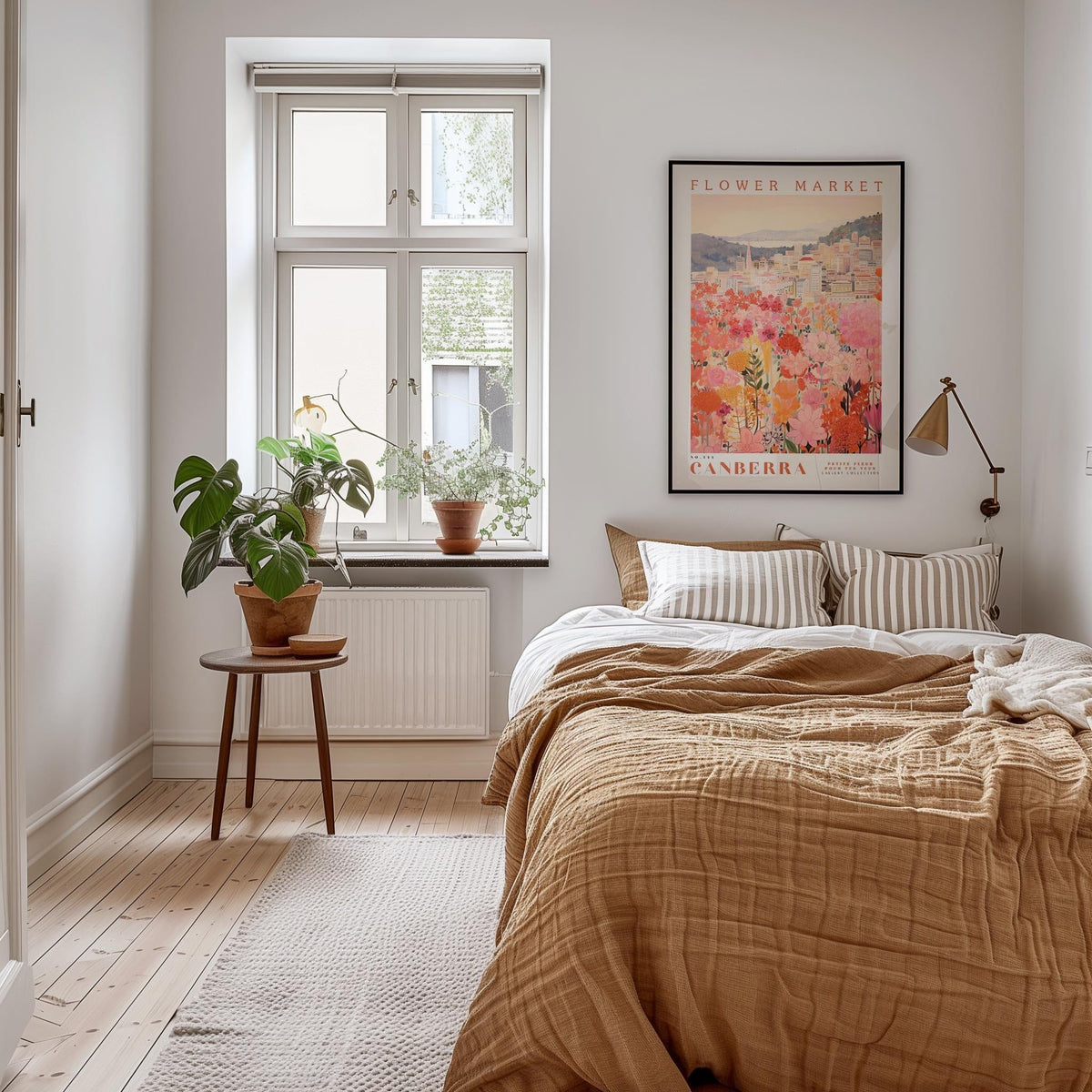 a cozy bedroom with a large bed, a wooden nightstand, and a large window with a plant on the sill. The room has a warm, inviting atmosphere with a neutral color palette and natural elements like the potted plant and the framed poster on the wall.