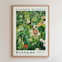 The image is a framed poster depicting a lush, colorful garden scene with various flowers, plants, and foliage.
