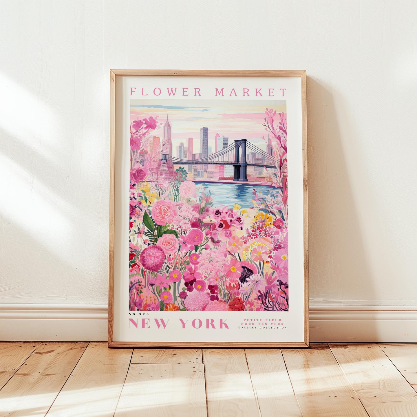 A framed poster of a flower market in New York, featuring a colorful illustration of a bridge and flowers in the foreground and background.
