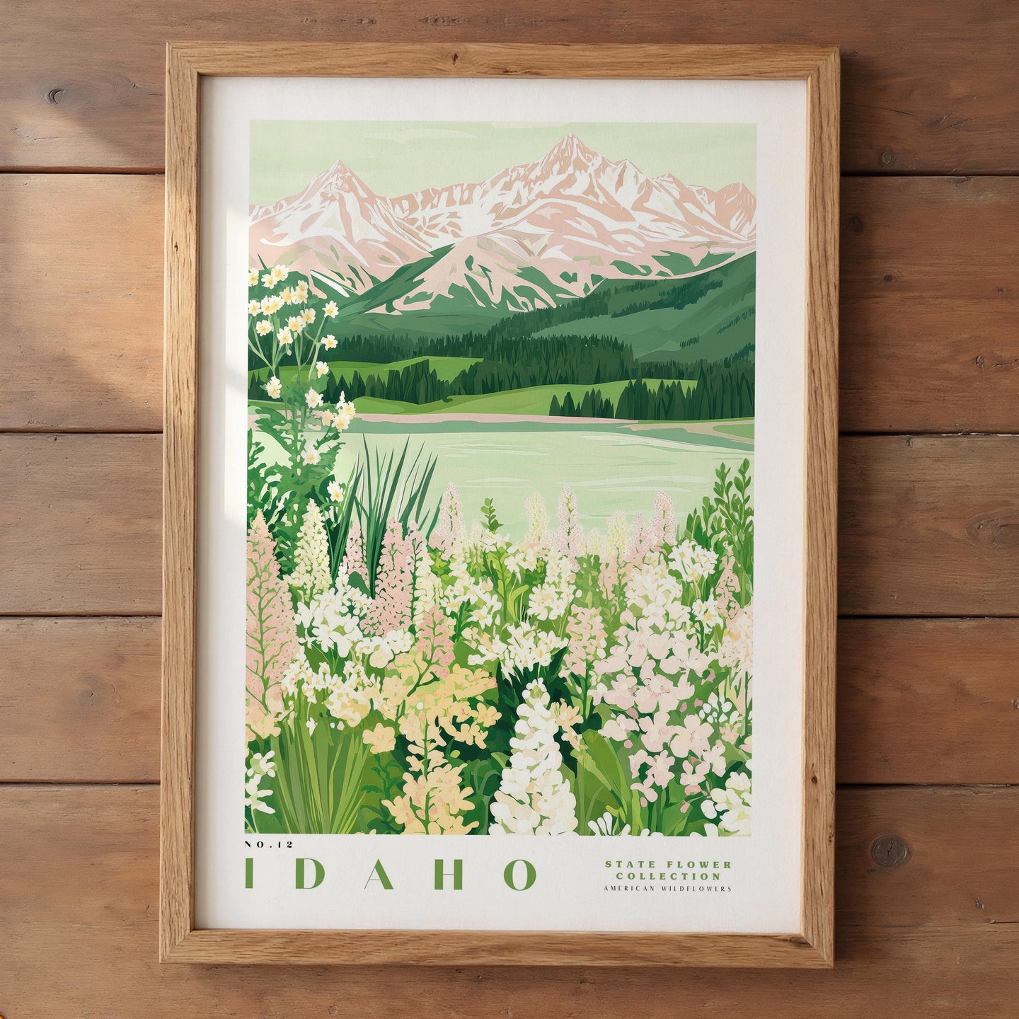 The image is a framed poster depicting a scenic landscape with mountains, a lake, and a field of flowers.