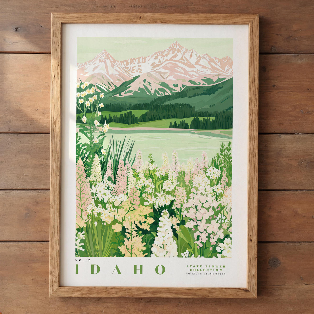 The image is a framed poster depicting a scenic landscape with mountains, a lake, and a field of flowers.