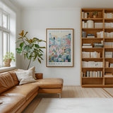 a cozy living room with a large bookshelf filled with books, a comfortable leather couch, and a large framed poster of a flower market hanging on the wall.
