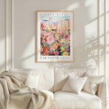 a framed poster of a colorful flower market in Las Vegas, with a cityscape in the background.