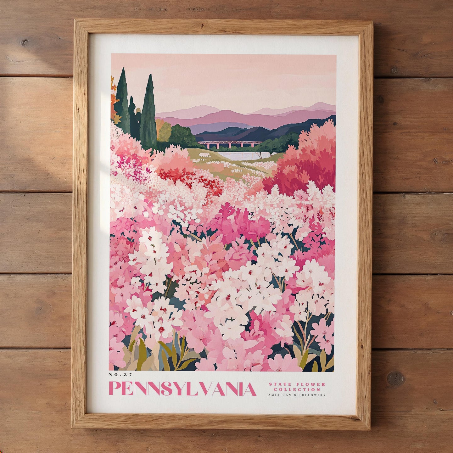 The image is a framed poster depicting a scenic landscape of a field filled with pink and white flowers, with mountains in the background.