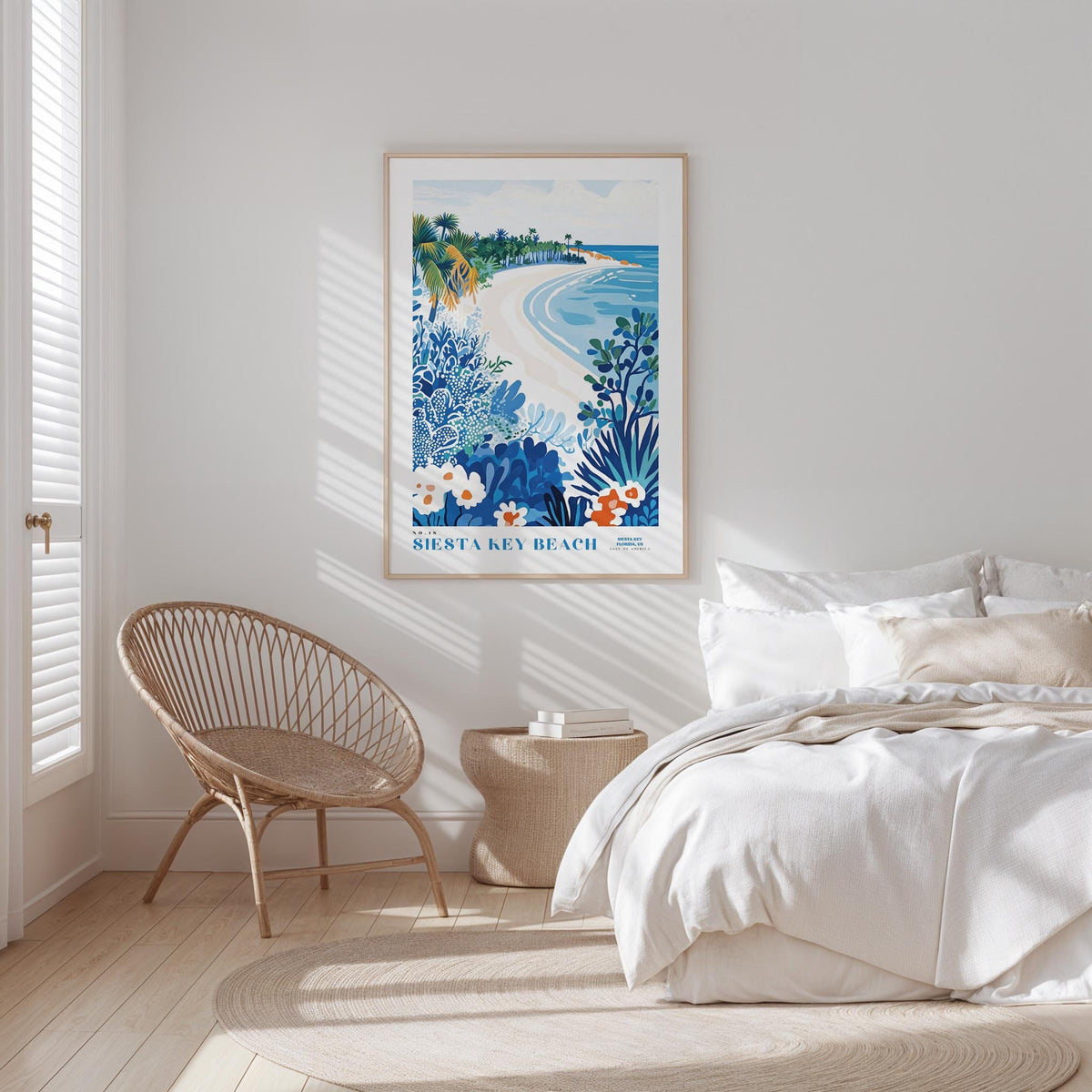 a serene bedroom scene with a large framed poster of a beach on the wall, a wicker chair, and a bed with white bedding.