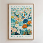 The image is a framed poster depicting a vibrant and colorful flower market scene in Hanoi, Vietnam.