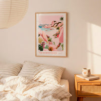 a bedroom with a bed, a nightstand, and a framed poster of a tropical beach scene hanging on the wall.