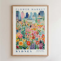 The image is a framed poster depicting a vibrant and colorful flower market in Sydney, Australia.