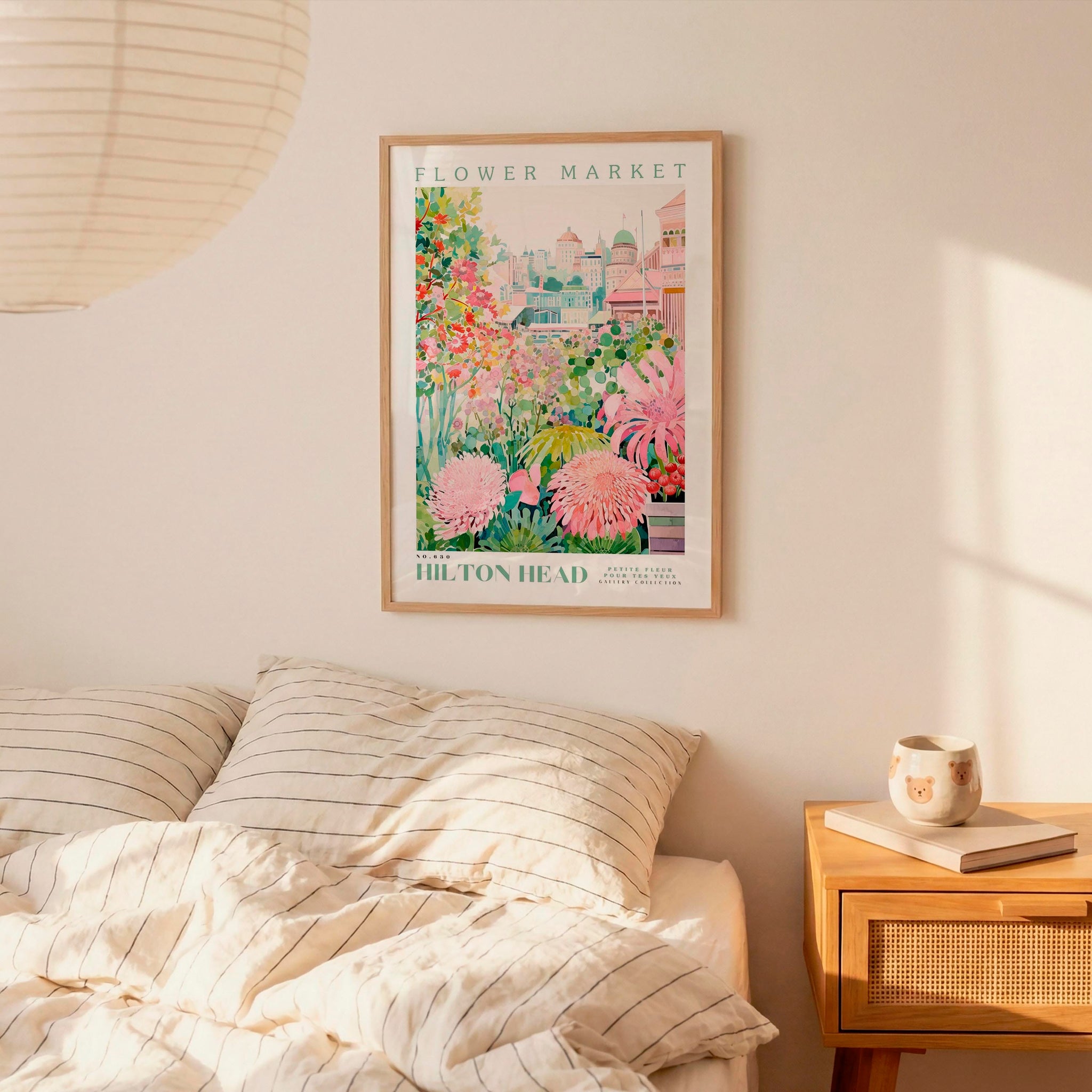 a bedroom with a bed, a nightstand, and a framed poster of a flower market hanging on the wall.