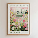 The image is a framed poster depicting a cityscape with a flower market in the background.