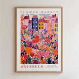 The image is a framed poster depicting a colorful and vibrant flower market in Brussels, Belgium.