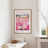a framed poster of a scenic view of West Virginia, with a vibrant display of pink and white flowers in the foreground.