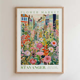 The image is a framed poster depicting a vibrant and colorful flower market scene.