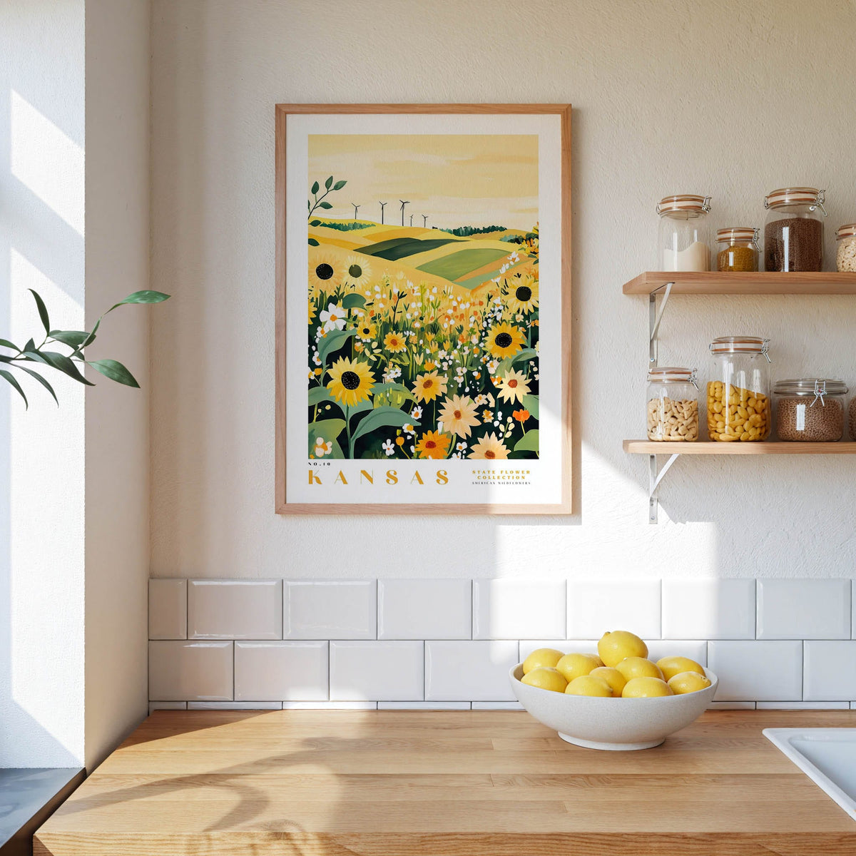 a kitchen scene with a framed print of a field of flowers hanging on the wall, a wooden counter with a bowl of lemons, and shelves displaying various jars and containers.