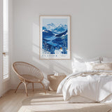 a serene bedroom scene with a large framed poster of a mountain landscape hanging on the wall, a wicker chair, and a bed with white bedding.