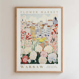 The image is a framed poster depicting a cityscape with a variety of colorful flowers in the foreground.