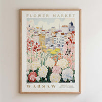 The image is a framed poster depicting a cityscape with a variety of colorful flowers in the foreground.