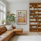 a cozy living room with a large bookshelf filled with books, a comfortable leather couch, and a large framed poster of a colorful floral scene hanging on the wall.