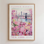 A framed poster depicting a vibrant floral scene with a cityscape in the background, including a bridge and skyscrapers.