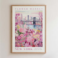 A framed poster depicting a vibrant floral scene with a cityscape in the background, including a bridge and skyscrapers.