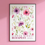 a picture of a flower market poster on a pink wall
