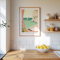 a kitchen scene with a framed poster of a beach, a bowl of lemons, and shelves with jars and bottles.