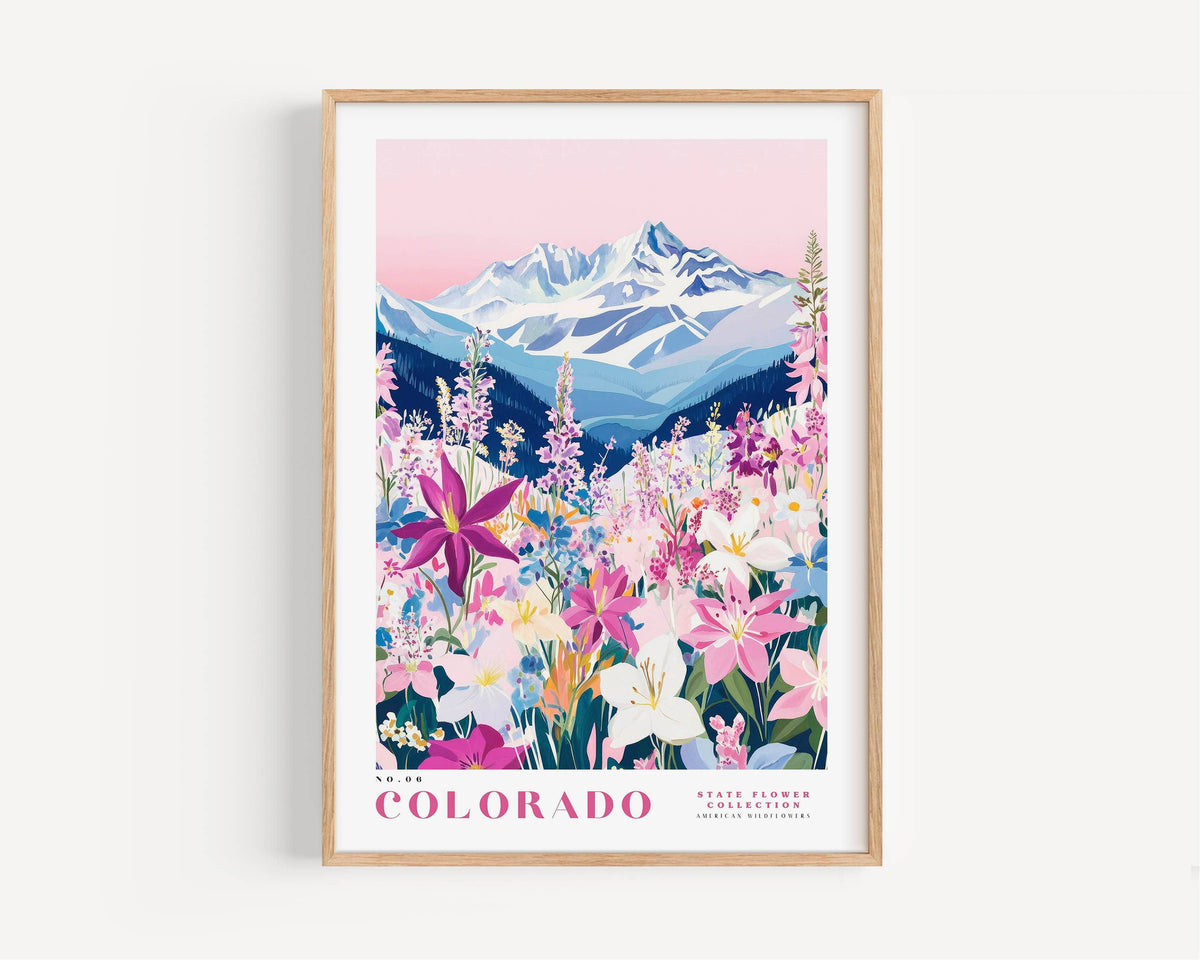 A framed poster depicting a vibrant mountain landscape with a variety of colorful flowers in the foreground.