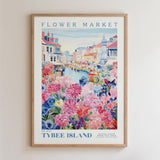 The image is a framed poster depicting a flower market in Tybee Island, with colorful flowers and buildings in the background.