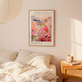 a bedroom with a bed, a nightstand, and a framed poster of a flower market in Stockton hanging on the wall.