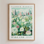 The image is a framed poster depicting a cityscape with a field of flowers in the foreground.