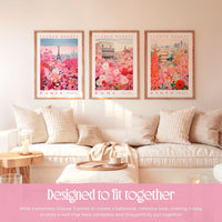 a cozy living room with three framed prints of flower market scenes hanging on the wall. The prints depict Paris, Rome, and Kyoto, creating a harmonious and visually appealing display. The arrangement of the prints and the matching pillows on the couch contribute to a cohesive and stylish atmosphere in the room.