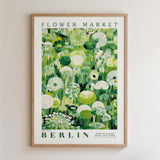 The image is a framed poster of a flower market in Berlin, featuring a collage of various green and white flowers and plants.