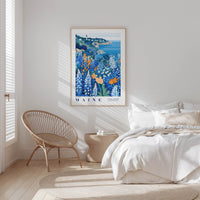 a serene bedroom scene with a large framed poster of a coastal landscape hanging on the wall, a wicker chair, and a bed with white bedding.
