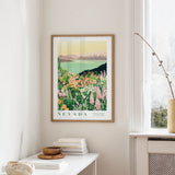 a framed poster of a scenic landscape of Nevada, with mountains, flowers, and a lake in the background. The poster is hanging on a wall, and there is a small table with a stack of books and a vase on it.