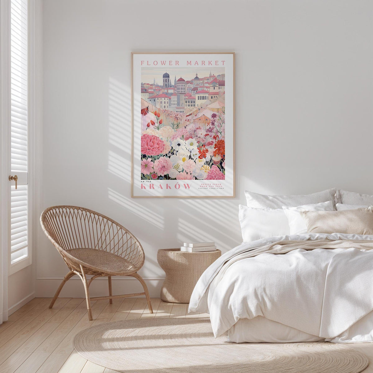 a bedroom with a bed, a woven chair, and a framed poster of a cityscape with flowers hanging on the wall.