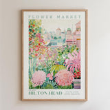 The image is a framed poster depicting a vibrant and colorful garden scene with various flowers and plants.