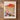 The image is a framed poster depicting a vibrant desert landscape with a variety of colorful flowers and cacti.