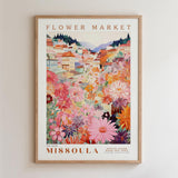 The image is a framed poster depicting a colorful and vibrant flower market in Missoula, Montana.
