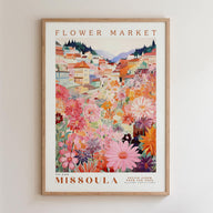 The image is a framed poster depicting a colorful and vibrant flower market in Missoula, Montana.