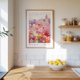 a kitchen scene with a framed poster of a flower market in the background, a wooden counter with a bowl of lemons, and shelves with jars and containers.