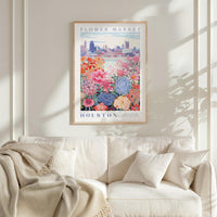a framed poster of a flower market in Houston, with a cityscape in the background.