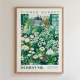 The image is a framed poster depicting a vibrant and lush flower market scene.