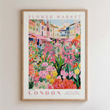 The image is a framed poster depicting a vibrant and colorful flower market in London.