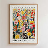 The image is a framed poster of a vibrant and colorful floral arrangement, depicting various flowers and plants in a lively and detailed manner.