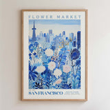 The image is a framed poster depicting a cityscape with a flower market in the foreground.