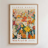 The image is a framed poster or print featuring a vibrant and colorful illustration of various flowers and foliage, including lilies, roses, and other blooms, set against a white background.