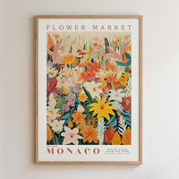 The image is a framed poster or print featuring a vibrant and colorful illustration of various flowers and foliage, including lilies, roses, and other blooms, set against a white background.