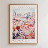 The image is a framed poster depicting a cityscape with a field of colorful flowers in the foreground.
