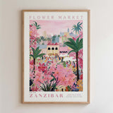 The image is a framed poster depicting a vibrant and colorful scene from the Flower Market in Zanzibar, featuring a variety of flowers, palm trees, and people enjoying the market.