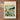 The image is a framed print depicting a scenic landscape of mountains, a lake, and a field of colorful wildflowers in Nevada.